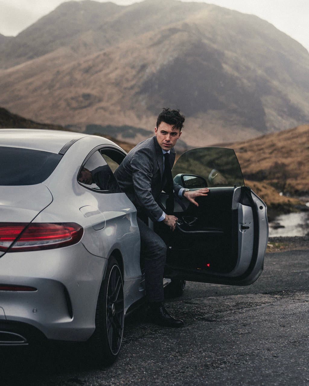Harry McGarrity stepping out of a car in the Scottish Highlands
