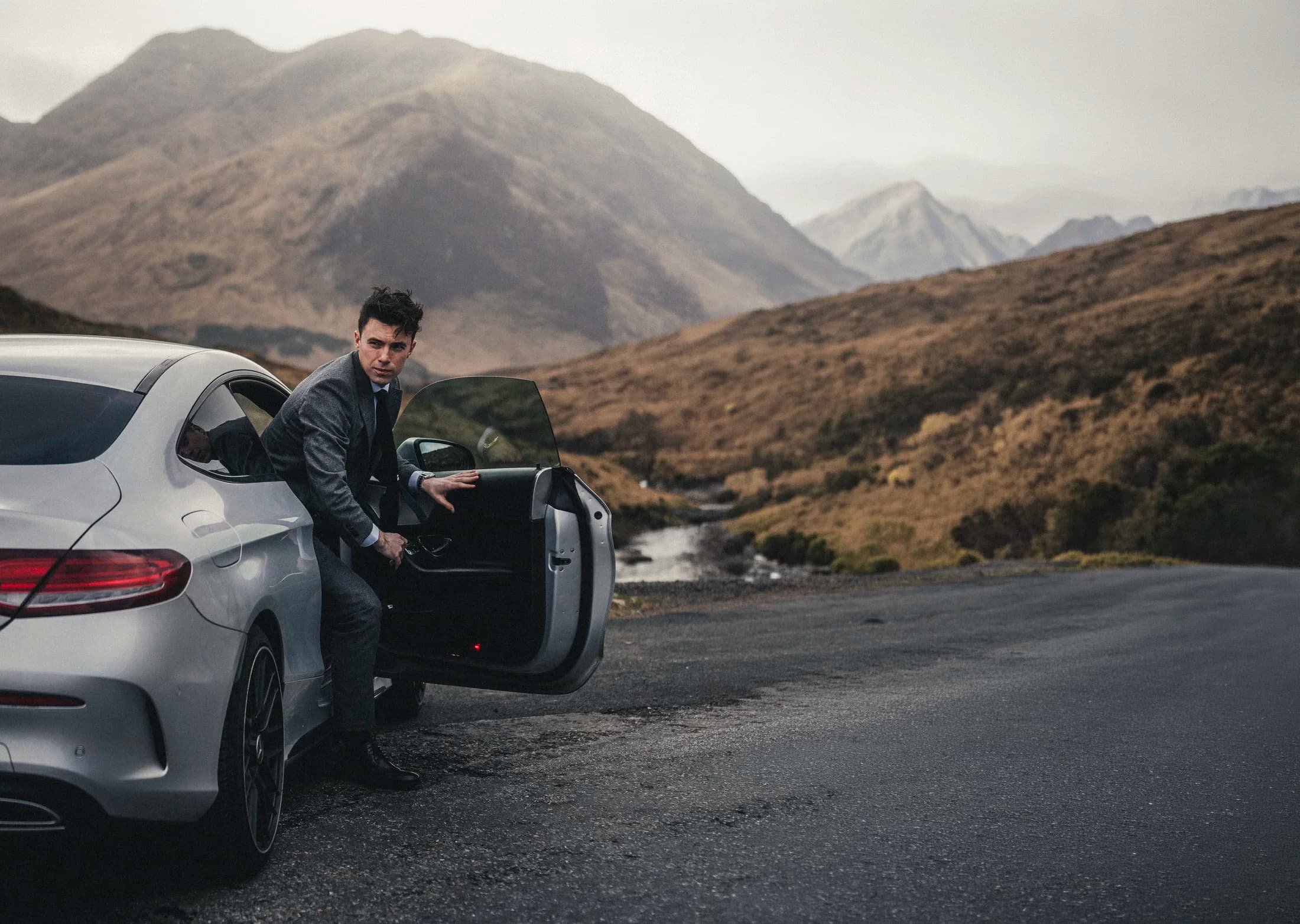 Harry McGarrity stepping out of a car in the Scottish Highlands